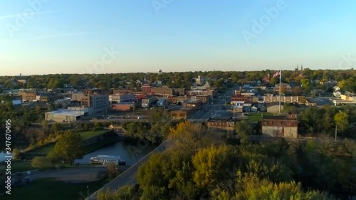 Small town in midwest USA tucked away in green forest, Aerial Wide Dolly photo