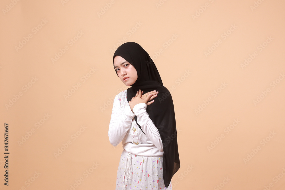 Portrait of Asian Muslim woman wearing a hijab feeling the pain of the background of a headache. Indonesian women Portrait of Asian Muslim woman wearing a hijab feeling the pain of the background of a headache. Indonesian women