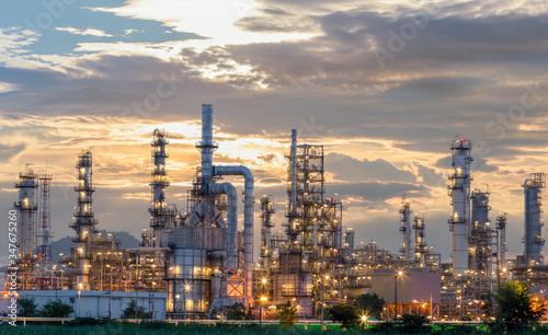 Oil refinery plant from industry zone, Aerial view oil and gas industrial, Refinery factory oil storage tank and pipeline steel at night.