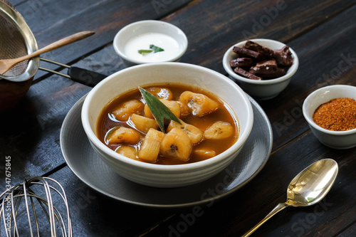 Banana Compote served with pandan leaf on the ceramic bowl. photo