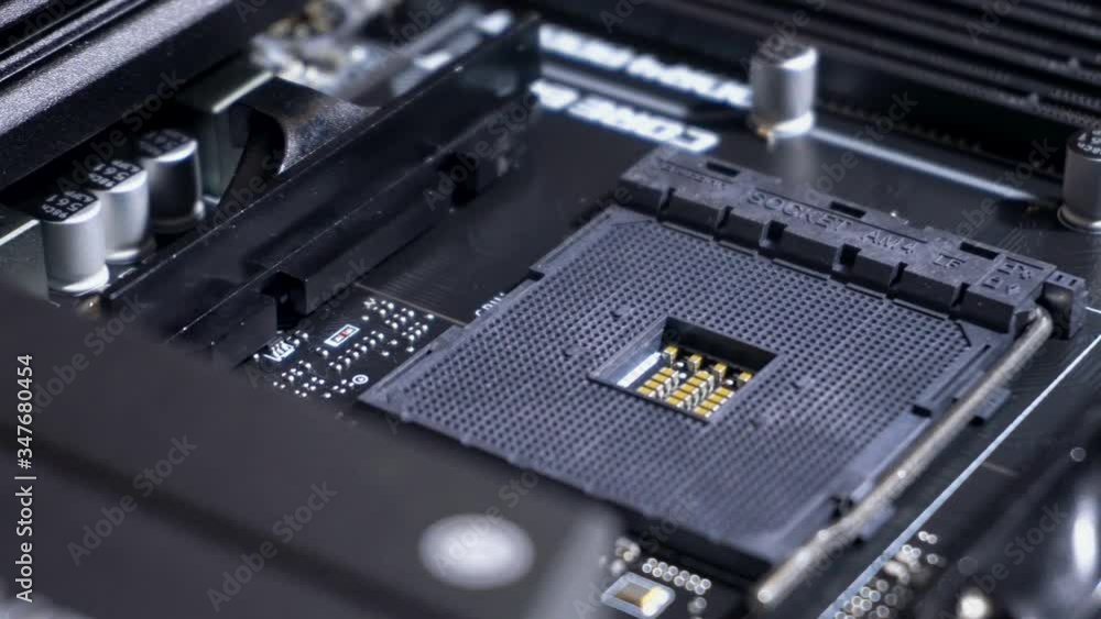 Central processing unit (CPU) pin grid array socket inside computer, slow pan right, close up Central processing unit (CPU) pin grid array socket inside computer, slow pan right, close up
