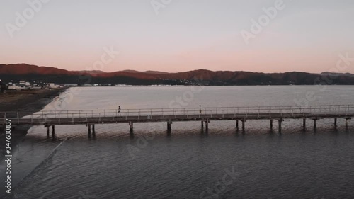Wallpaper Mural Teens skateboarding as drone reveals Petone Wharf in New Zealand Torontodigital.ca