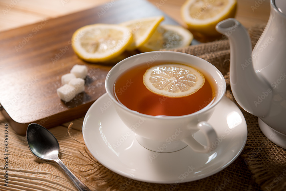 Cup of tea with lemon on wooden table Cup of tea with lemon on wooden table