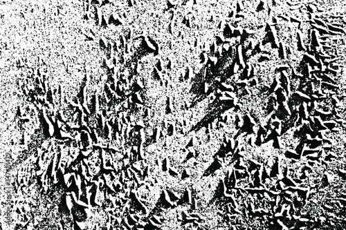 Grunge texture of a cracked surface that resembles a mountain landscape. Monochrome relief rocky background with cracks, spots, noise and grain. Overlay template. Vector illustration