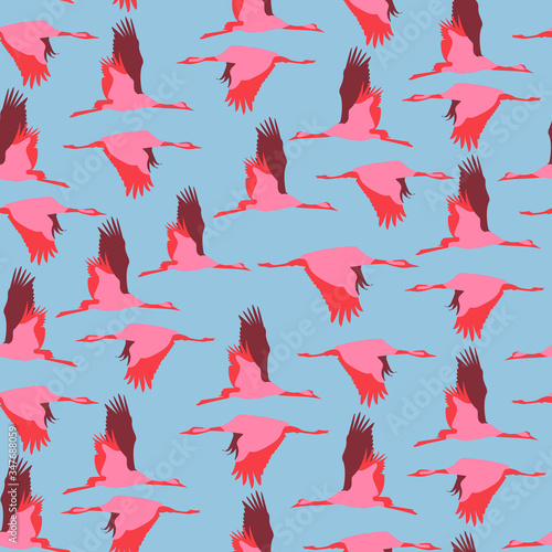 Seamless pattern with cranes - birds fly across the blue sky