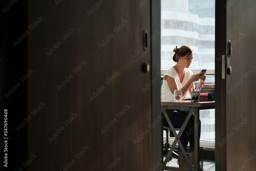 Woman Working In Corporate Office Sending Email With Phone Woman Working In Corporate Office Sending Email With Phone