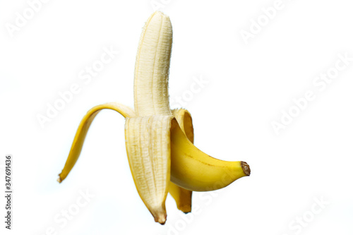 Half peeled ripe banana on white background. isolated