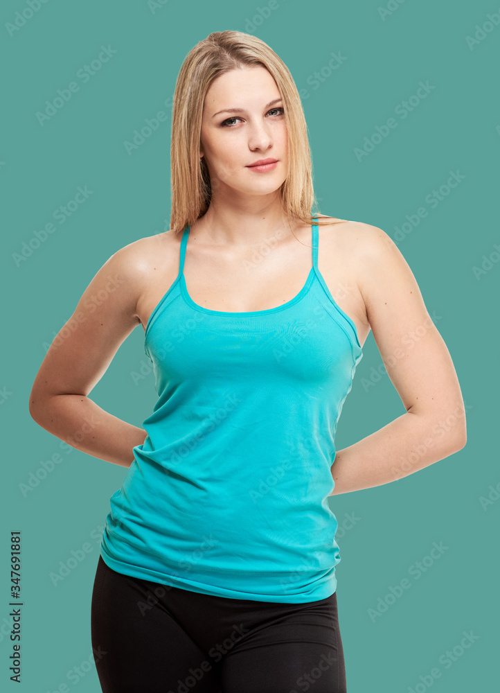 fitness woman. Young sporty Caucasian female model isolated on background jungle shade green color fitness woman. Young sporty Caucasian female model isolated on background jungle shade green color