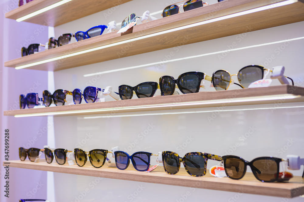 Storefront shelves of various modern sunglasses at the airport's retail store