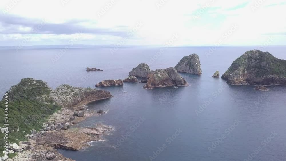 Aerial view of rocky island in Poor Knights Island Reserve in New Zealand Aerial view of rocky island in Poor Knights Island Reserve in New Zealand