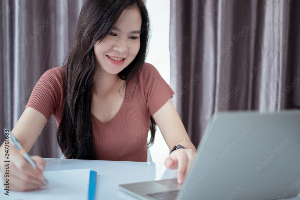 Asian woman working from home with laptop computer self isolation from society to reduce risk, quarantine prevention coronavirus, covid-19 and study e-learing online education technology concept. Asian woman working from home with laptop computer self isolation from society to reduce risk, quarantine prevention coronavirus, covid-19 and study e-learing online education technology concept.