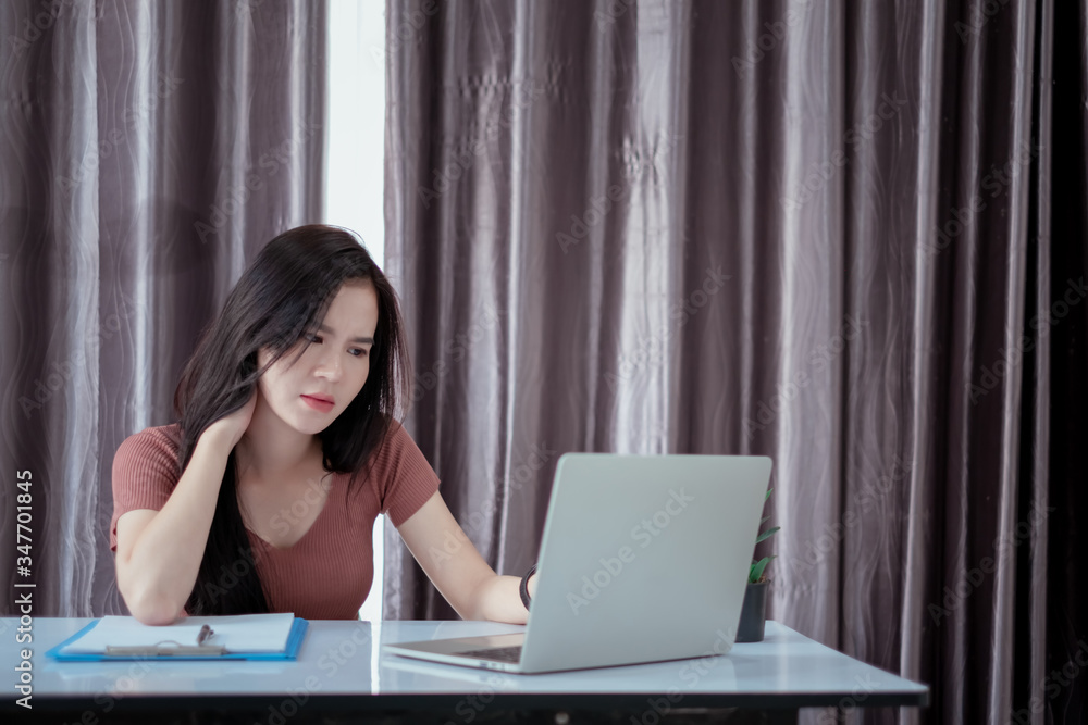 Asian woman wokring from home office overworked stressed deadline on laptop computer unhappy emotion workhard sleepless when quarantine crisis coronavirus, covid-19 prevention reduce risk concept. Asian woman wokring from home office overworked stressed deadline on laptop computer unhappy emotion workhard sleepless when quarantine crisis coronavirus, covid-19 prevention reduce risk concept.
