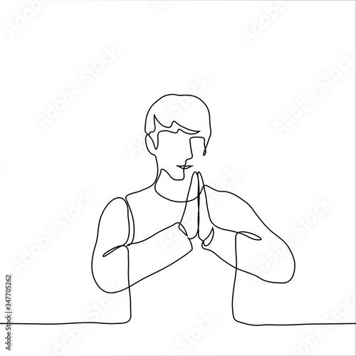 The man folded his hands together at chest level. The concept of reassurance, prayers to someone, attempts to concentrate, a pose from yoga, meditation. One continuous line drawing of a man meditating