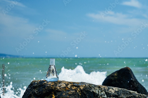 Glass bulb. Sea shore. Waves hit the stones.
