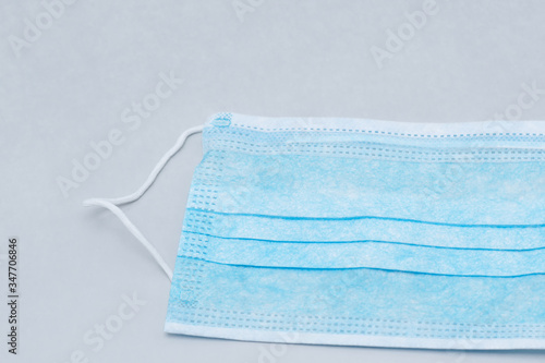 Blue medical mask on a gray background