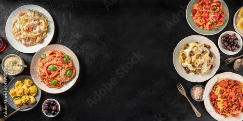 Pasta Design Panorama. Assortment of Italian pasta dishes, including spaghetti Bolognese, penne with chicken, and many others, shot from above on a black background with copy space