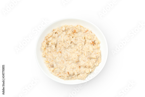 Plate with cooked oatmeal isolated on white background