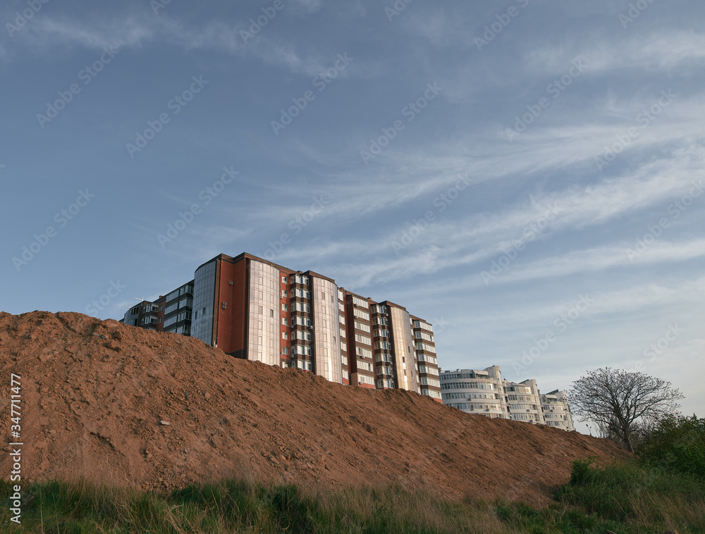 Fototapeta premium council apartment house tower flat block of apartments viewed from below. Ground and gravel in front of house