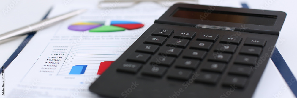 The black calculator lies on a chessboard. The black calculator lies on a chessboard.