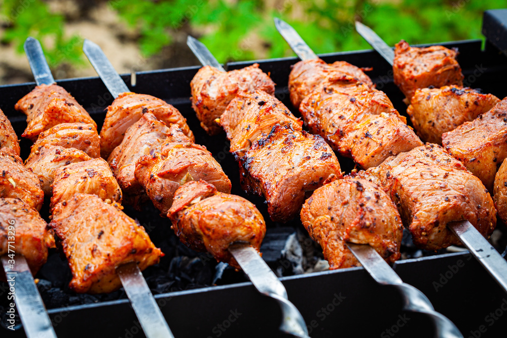 Homemade grilled pork kebab on an outdoor open grill. Outdoor food festival.