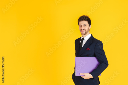 A businessman with the yellow isolated background.