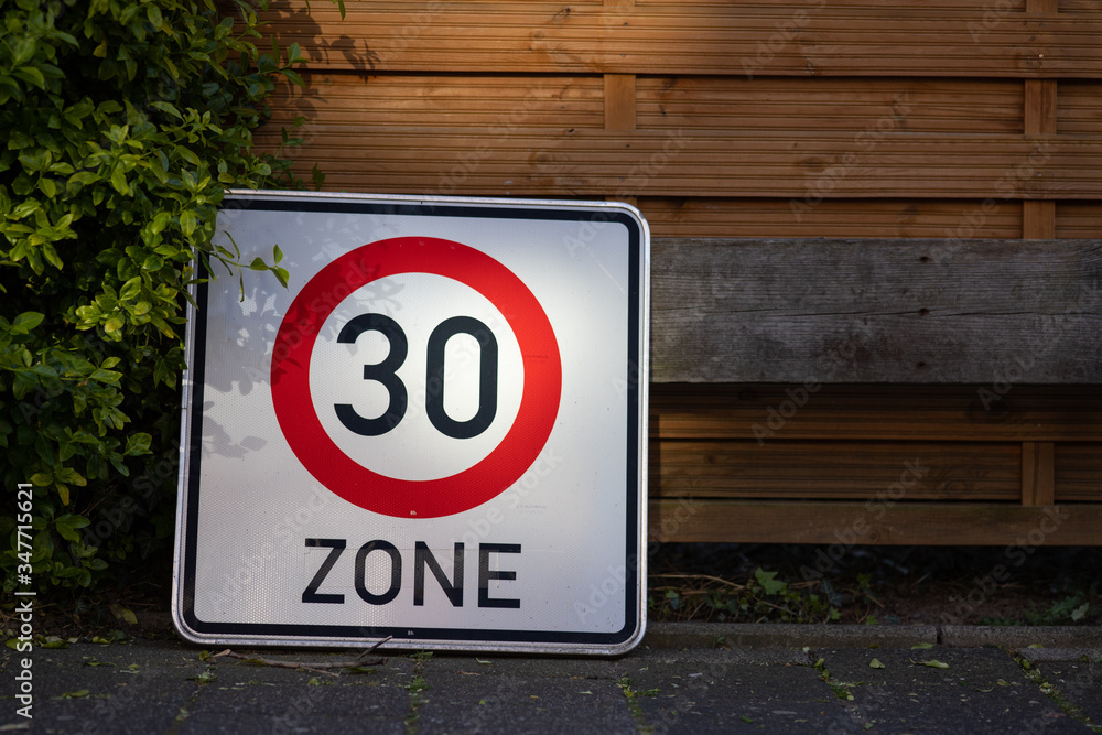 Speed Limit sign on the pavement of a residential area in Germany Speed Limit sign on the pavement of a residential area in Germany