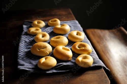 Fresh Homemade Bagels on a Kitchen Tower on a dark wooden table
