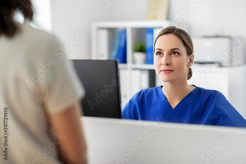 medicine, people and healthcare concept - female doctor or nurse with computer and patient at hospital