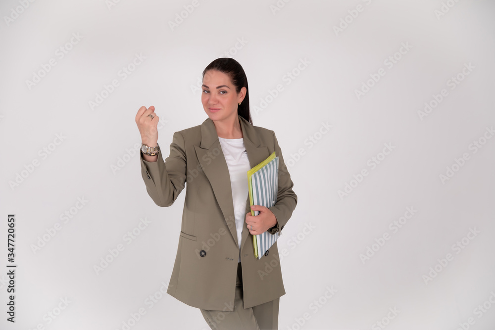 business woman on grey background with copy space. boss shakes a fist business woman on grey background with copy space. boss shakes a fist
