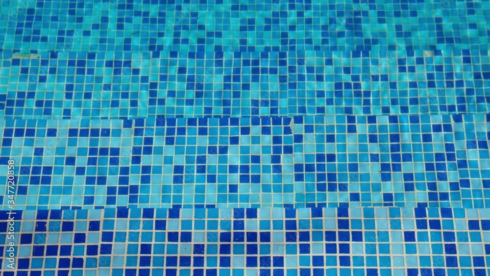 The blue tiled bottom background, of swimming pool. Cyprus The blue tiled bottom background, of swimming pool. Cyprus