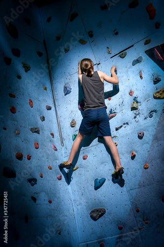 Teenage Boy Training On Climbing Wall