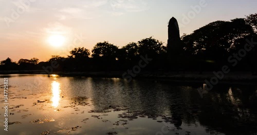 Sunset and evening light, light and reflection on the water, at the Old Chedi Thai temple in Ayutthaya photo