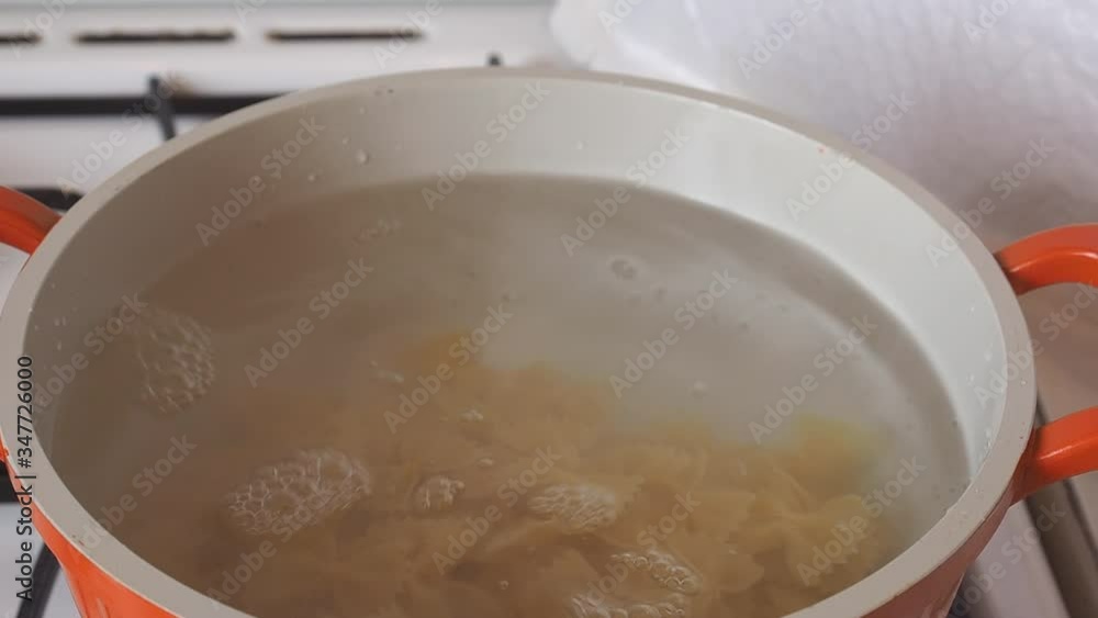 In a pot of boiling water cook falls asleep Dry Italian pasta macaroni bows farfalle. In a pot of boiling water cook falls asleep Dry Italian pasta macaroni bows farfalle.