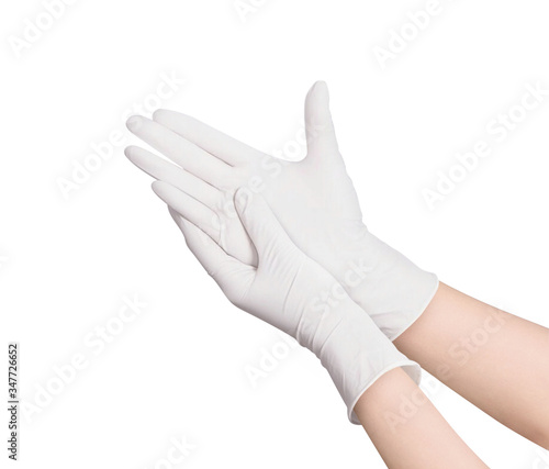 Two white surgical medical gloves isolated on white background with hands. Rubber glove manufacturing, human hand is wearing a latex glove. Doctor or nurse putting on nitrile protective gloves