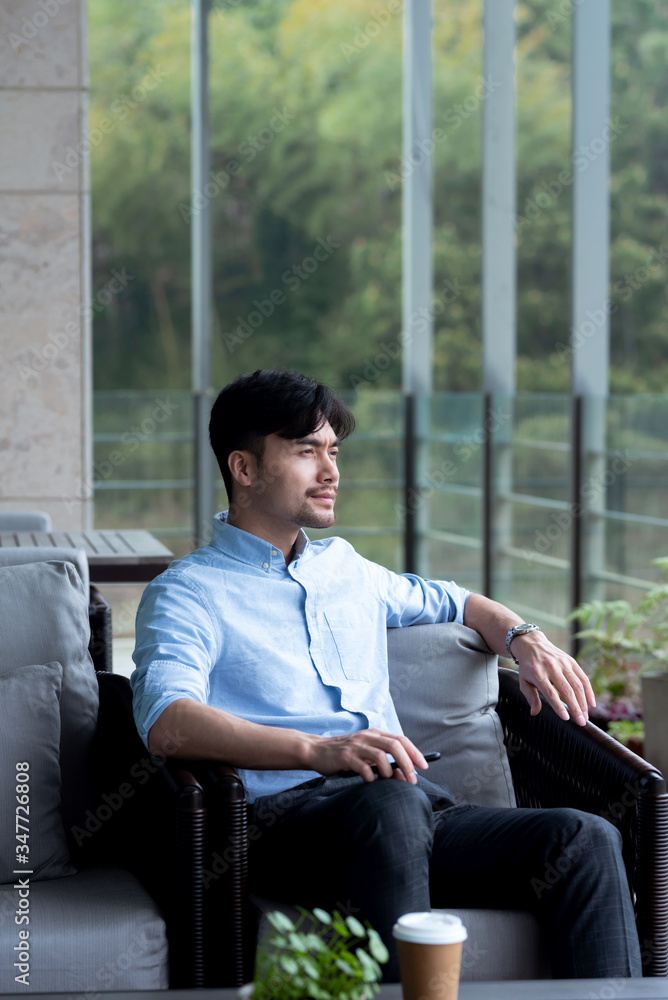 Asian business male resting in the outdoors Asian business male resting in the outdoors