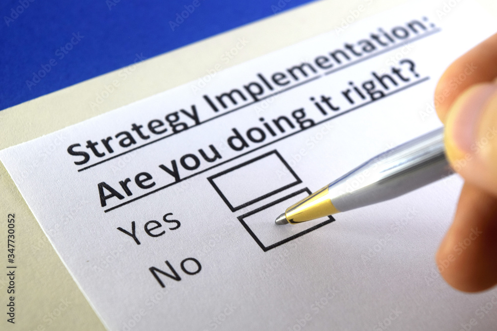One person is answering question about strategy implementation. One person is answering question about strategy implementation.