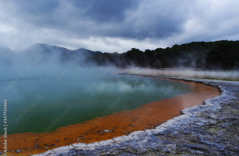 Geothermal lake with an orange shoreline