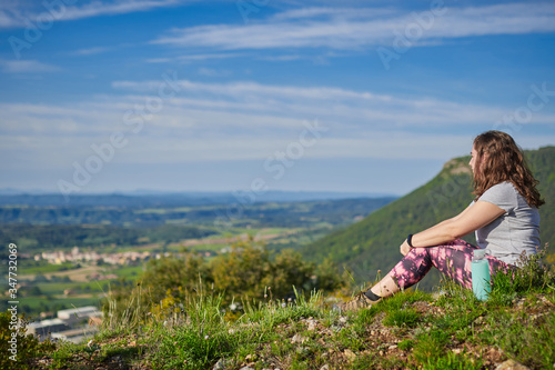 girl sitting in the bush, on one side, there is copy space