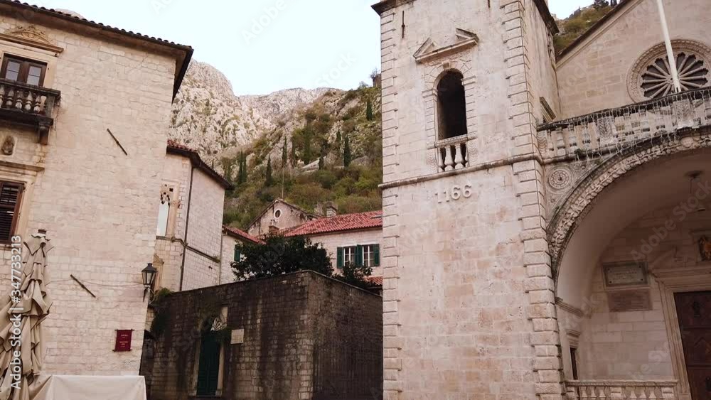 Cathedral of Saint Tryphon Square in old town of Kotor in handheld motion shot. The oldest Cathedral in Montonegro (Yugoslavia) Cathedral of Saint Tryphon Square in old town of Kotor in handheld motion shot. The oldest Cathedral in Montonegro (Yugoslavia)