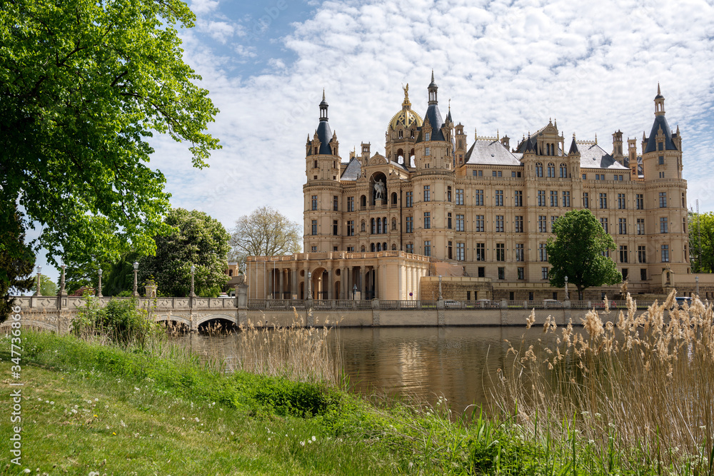 Schwerin Castle or Schwerin palace, in German Schweriner Schloss, a famous landmark building on a lake in the capital city of Mecklenburg
