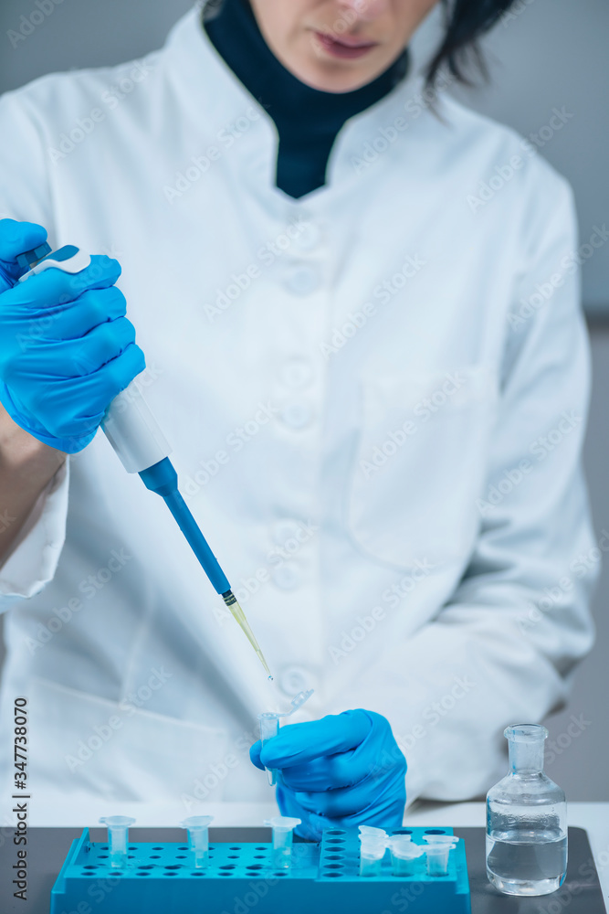 Fototapeta premium Placebo Controlled Study - Laboratory Technician Preparing Control Treatments for a Placebo Controlled Study