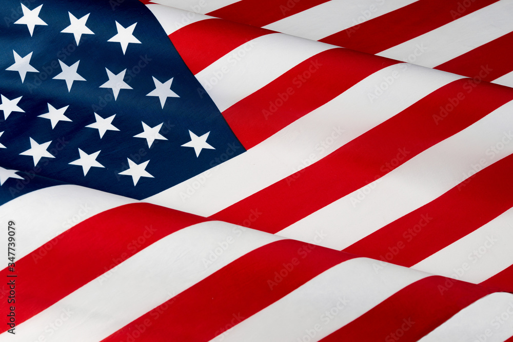 Close up of ruffled American flag. Satin texture curved flag of USA. Memorial Day, 4th of July. Banner, freedom concept Close up of ruffled American flag. Satin texture curved flag of USA. Memorial Day, 4th of July. Banner, freedom concept