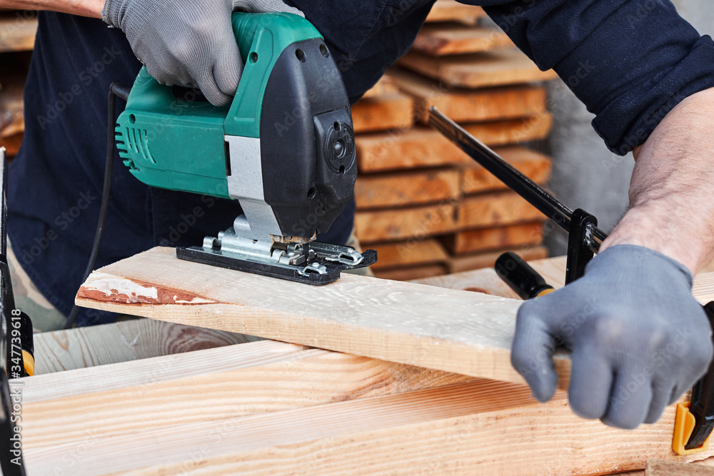 Carpenter working with plane on wooden background. Man hand with professional instrument repairing, fixing, building construction