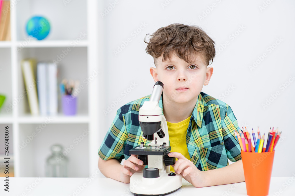 Portrait of a young boy with microscope at home Portrait of a young boy with microscope at home
