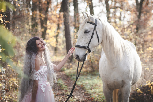 Beautiful girl with the white horse