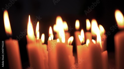 Many candles in the dark with a beautiful bokeh. photo