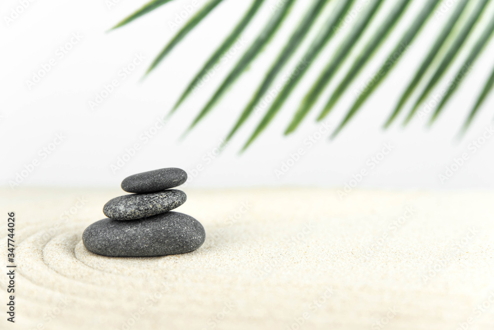 Zen garden. Pyramids of white and gray zen stones on the white sand with abstract wave drawings. Concept of harmony, balance and meditation, spa, massage, relax. Zen garden. Pyramids of white and gray zen stones on the white sand with abstract wave drawings. Concept of harmony, balance and meditation, spa, massage, relax.