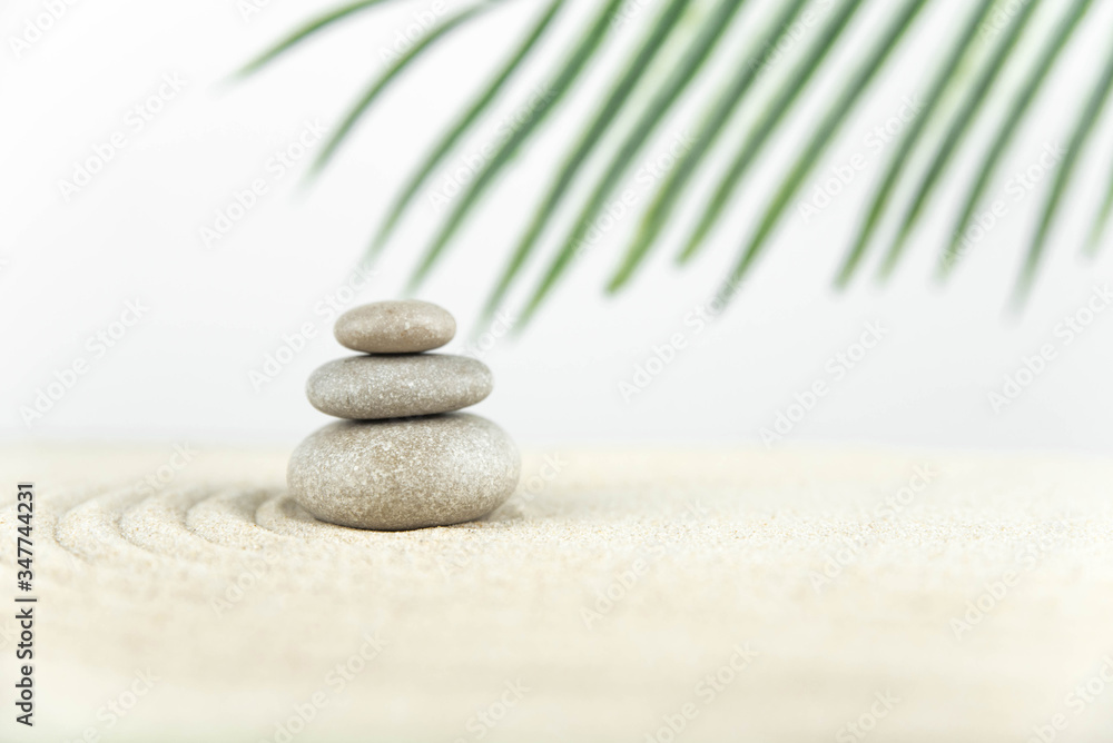 Zen garden. Pyramids of white and gray zen stones on the white sand with abstract wave drawings. Concept of harmony, balance and meditation, spa, massage, relax. Zen garden. Pyramids of white and gray zen stones on the white sand with abstract wave drawings. Concept of harmony, balance and meditation, spa, massage, relax.