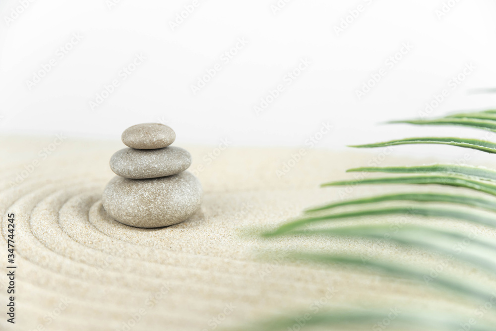 Obraz premium Zen garden. Pyramids of white and gray zen stones on the white sand with abstract wave drawings. Concept of harmony, balance and meditation, spa, massage, relax.
