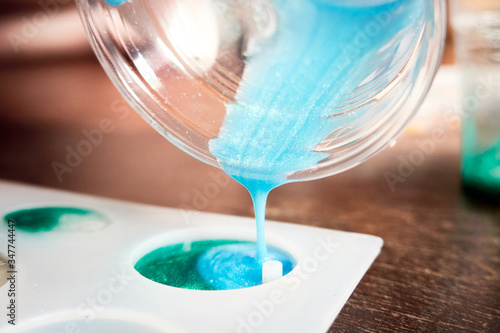 Pouring glitter blue resin into mold , Process of prepare for make an accessories from resin